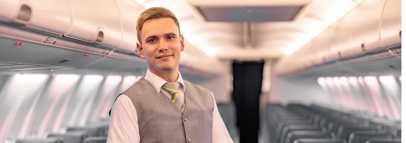 Male cabin crew member wearing modern gray vest and striped tie