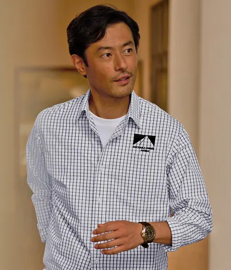 A man wearing a blue and white checkered dress shirt.