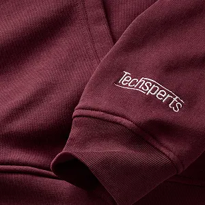 A burgundy sweater with an embroidered company logo.