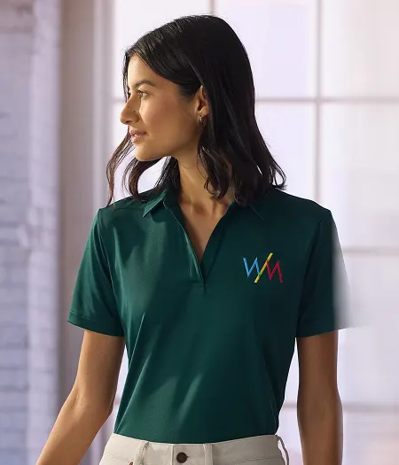 A woman wearing an green polo shirt.