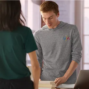 A man wearibng a gray long-sleeve top.
