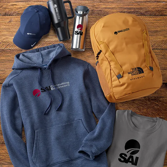 A laydown of promotional gear such as a hat, hoodie, backpack, t-shirt, and drinkware.