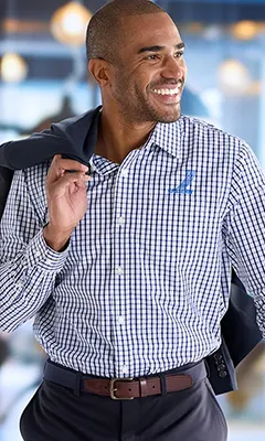 A man wearing a checkered broadcloth dress shirt.