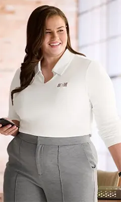 A woman wearing a white supima cotton top.