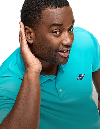 Man wearing a teal flagship performance polo.