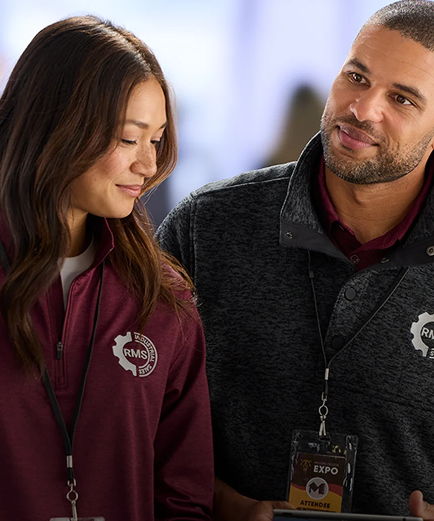 Woman wearing a fleece pullover and man wearing a fleece jacket.