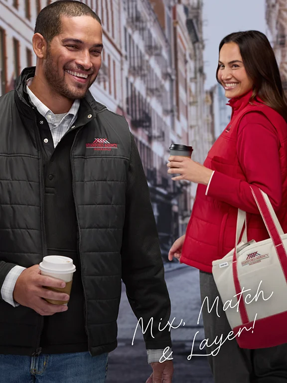 Mix, Match and Layer! - A man and woman holding coffee and wearing pullovers and fleece vests.
