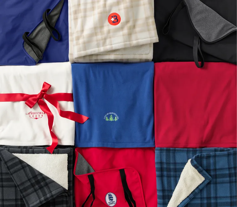 Several fleece products folded and arranged to make a pattern of three rows with three columns.