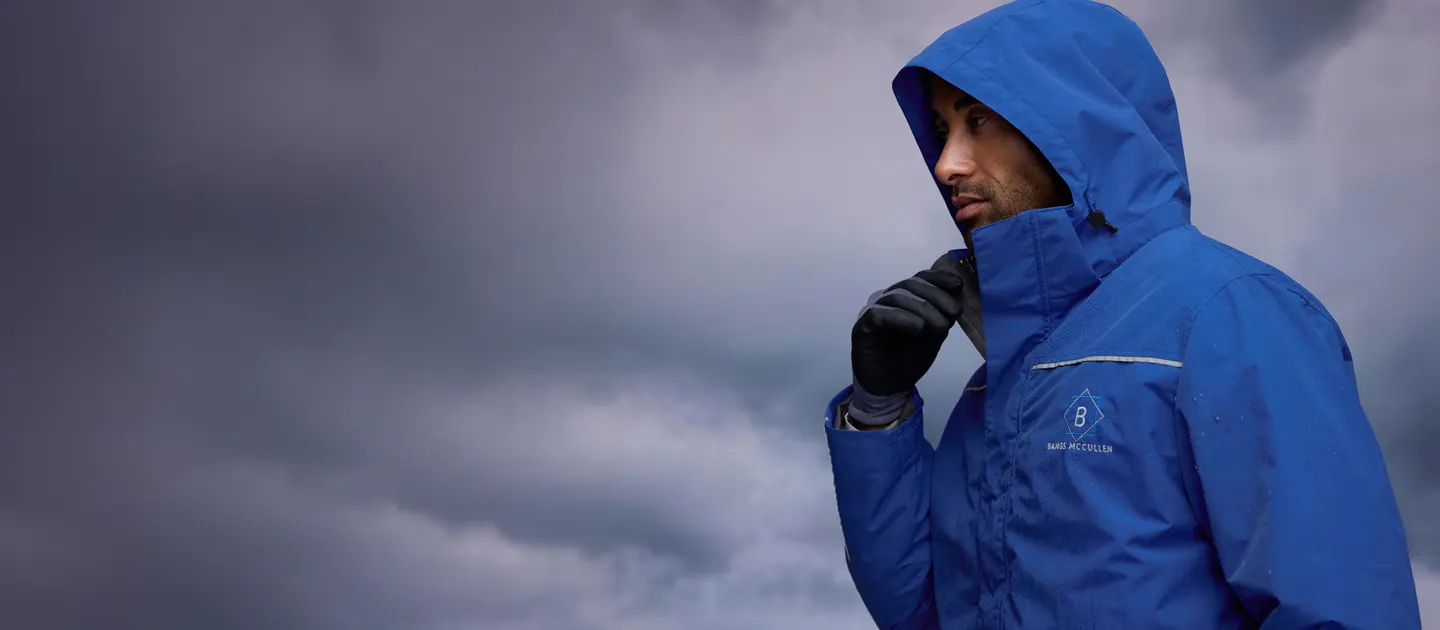 A man wearing a blue squall jacket.