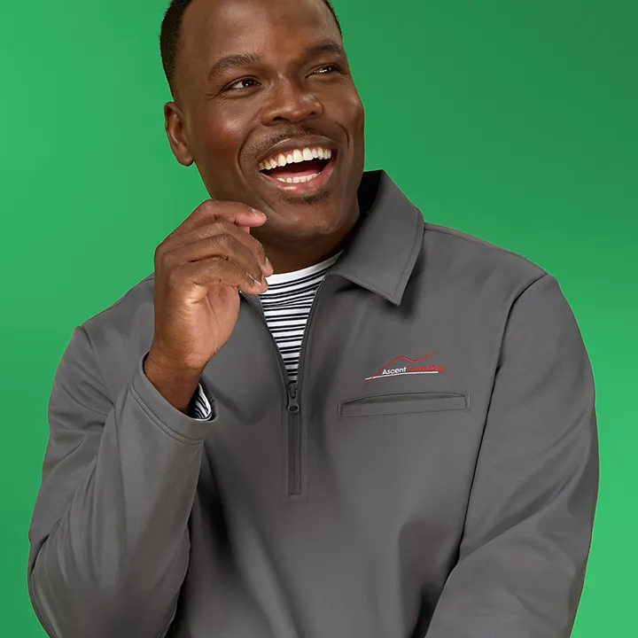 A man wearing a gray quarter zip jacket.