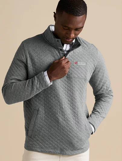 Man wearing a gray snap neck quilted pullover