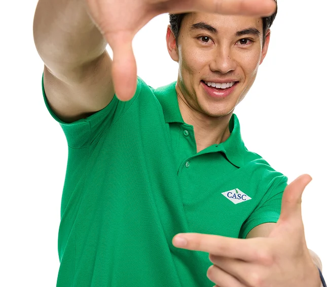 Man wearing a green essential pique polo.