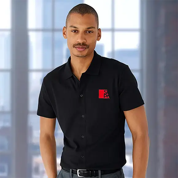 An employee wearing a black supima polo.