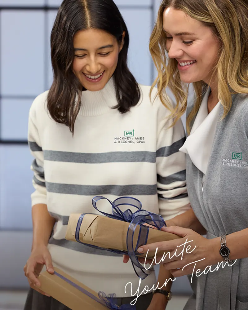 Unite Your Team - Two employees exchanging gifts.