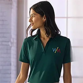 A woman wearing a green polo shirt.
