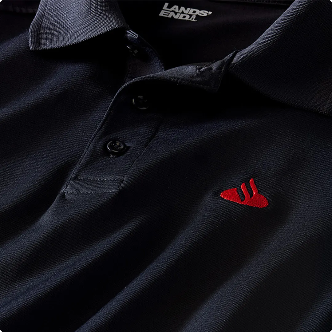 A black polo with a red Santander logo.