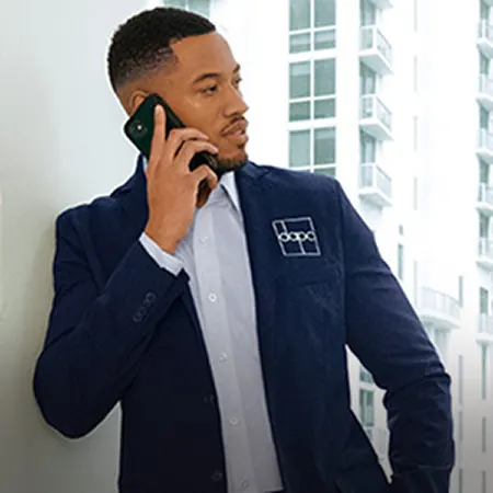 A man on a phone wearing a suit jacket.