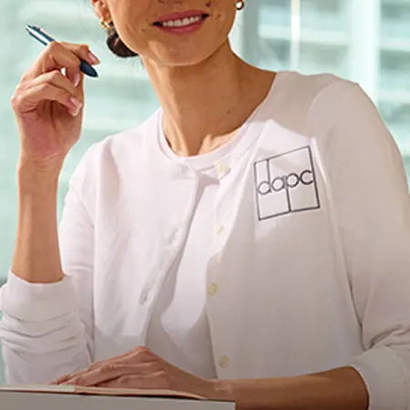 A woman wearing a white blouse.