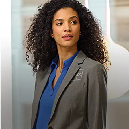 A woman wearing a gray suit jacket.