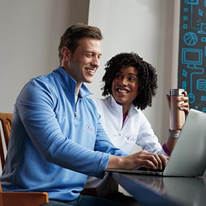 A man and a woman looking at a laptop.