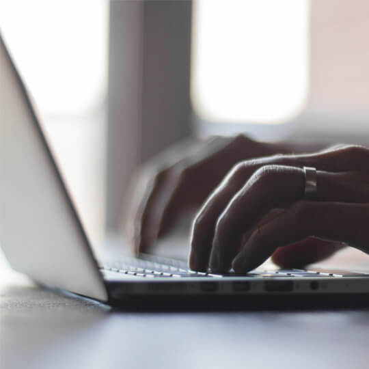 A person typing on a laptop.