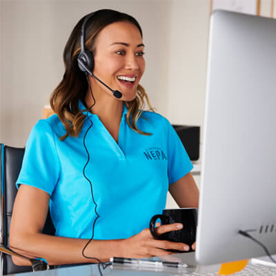 A customer service representitive working at a computer.