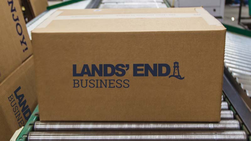 A Lands’ End Business shipping box on a conveyor belt.