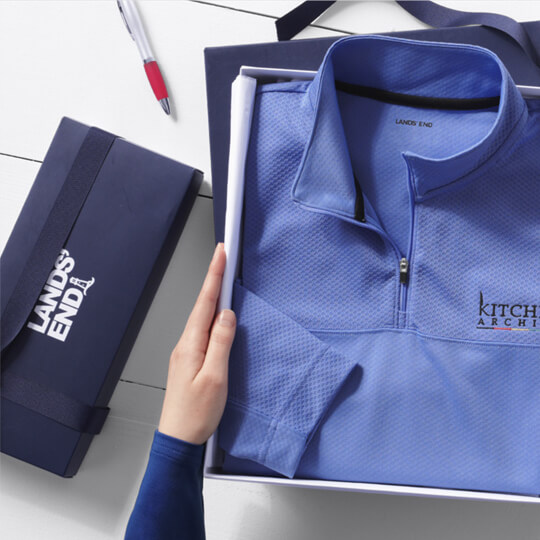 A person opening Lands› End Business gift boxes.